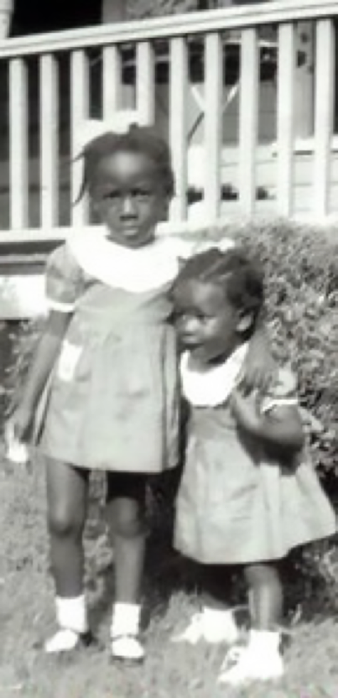 Wambui with sister, 1953. (Wambui is the short one.)