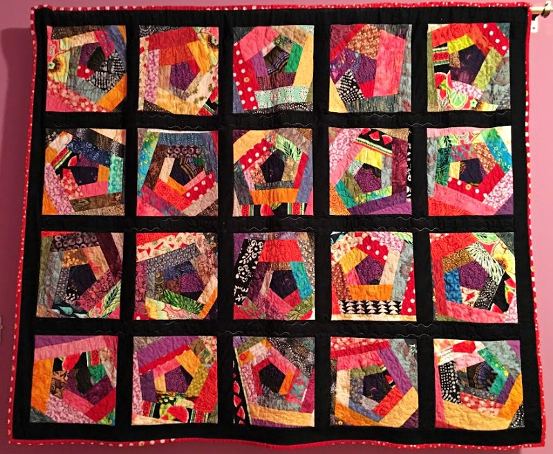Crazy Quilt
This colorful quilt hangs proudly on the wall in my oldest daughter's home, and I had a great time putting it together! The process was both simple and creative. I started by cutting enough pieces to create matching shapes for the centers of each block. Once the center shapes were ready, I let my creativity flow by piecing fabric around each center. I used a variety of fabrics I had on hand, adding strips and shapes until all the blocks reached a specific size. The beauty of this quilt lies in its "crazy" and random patterns, which come together in such a lively, vibrant way!